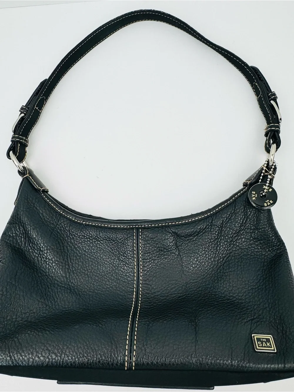 The Sak Baggett hobo. Pebbled leather. Silver-tone hardware. Slouchy Y2K style